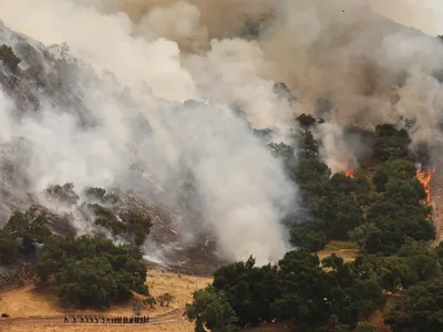 Firefighters&nbsp;work to contain the Lake Fire burning in Los Padres National Forest in California. More than 3,900 fires have spread across California this year.